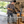 A man wearing a welding helmet and gloves works at a wooden workbench in a home garage, using a clamp to hold a metal bracket. Text on the image reads 'Made for Weekend Repairs Around the House' and 'Stick Welder Setup for Home Garage and Yard.